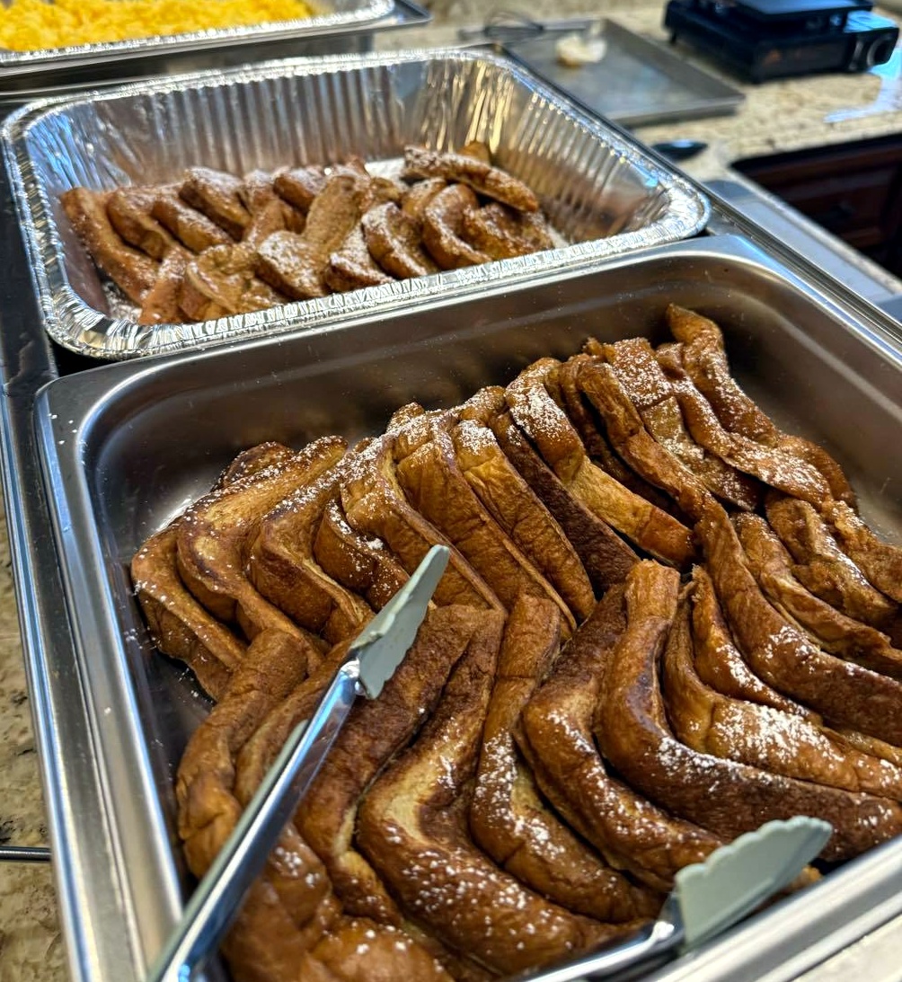 Catering trays filled with sliced cinnamon sugar pastries for drop-off meal service