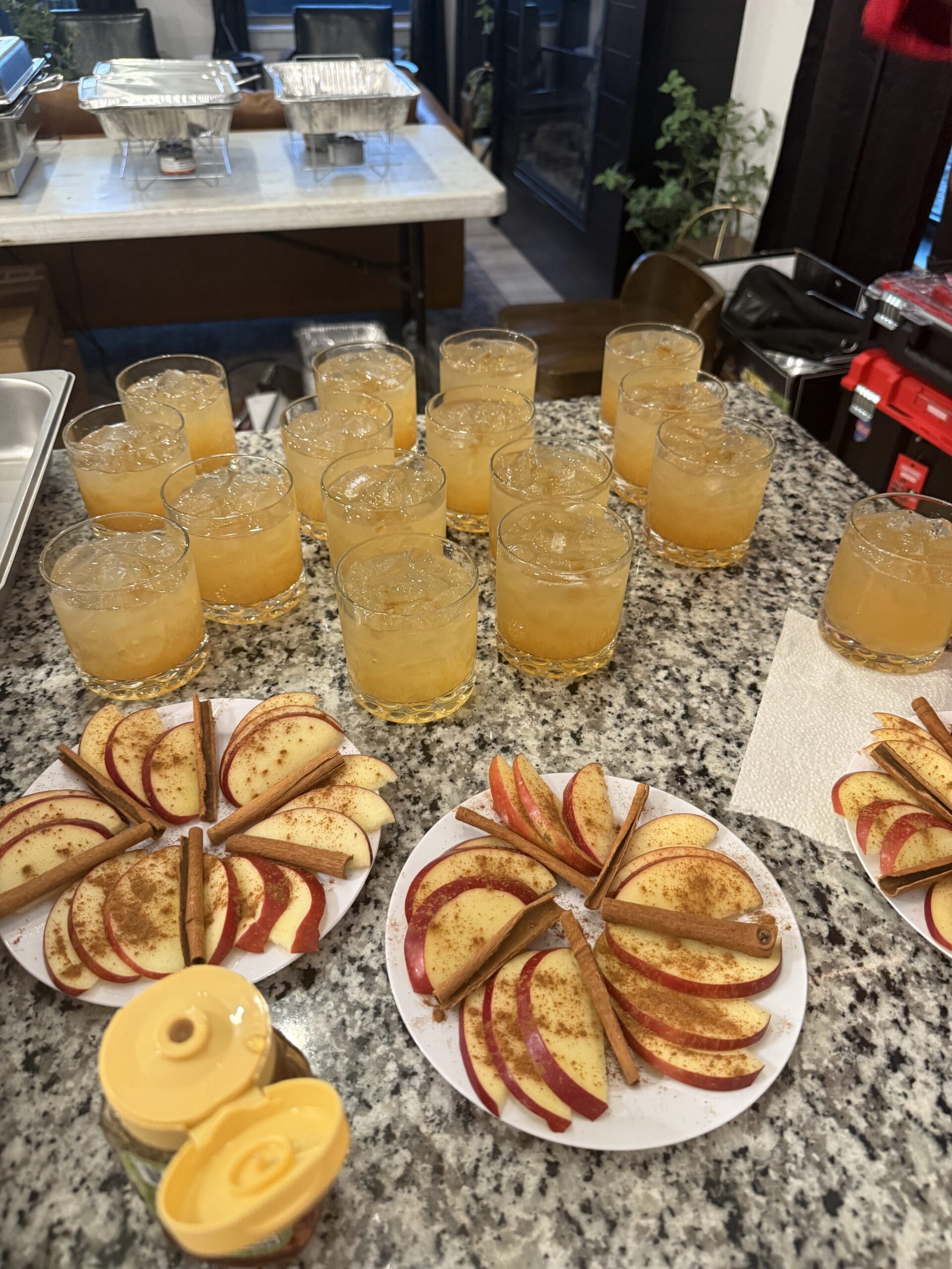 Apple slices with cinnamon and bourbon-colored cocktails arranged on a granite countertop for a steakhouse pairing dinner