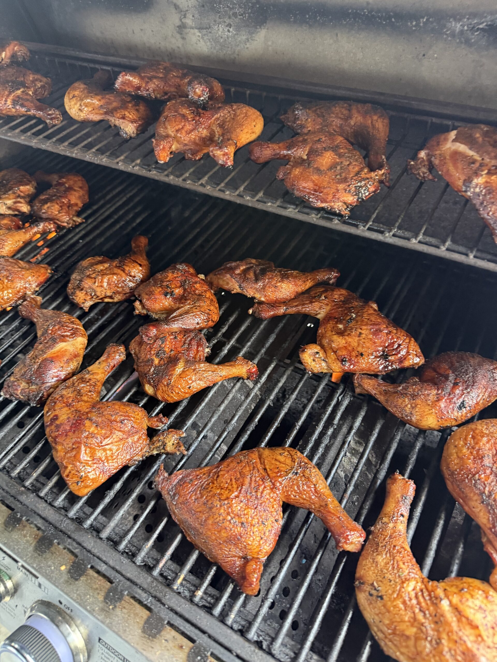 Grilled chicken leg quarters on a barbecue grill